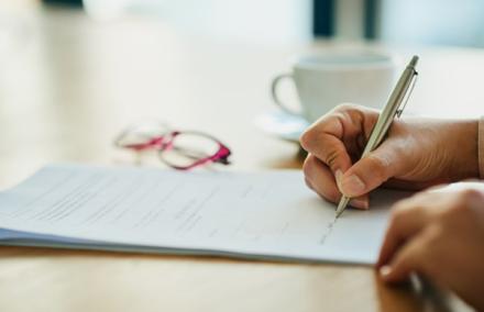 Someone signing a document